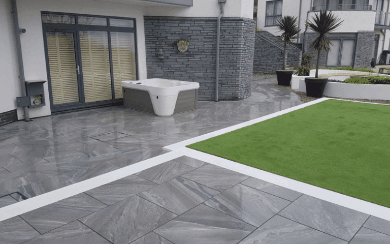 Beautiful and spacious Devon garden with paving, a hot tub, astroturf and seating.